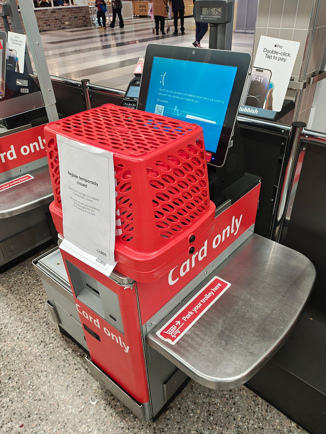 A self-serve supermarket checkout register showing an out-of-order error screen and closed to customers, Melbourne, Australia, the day after the outage.