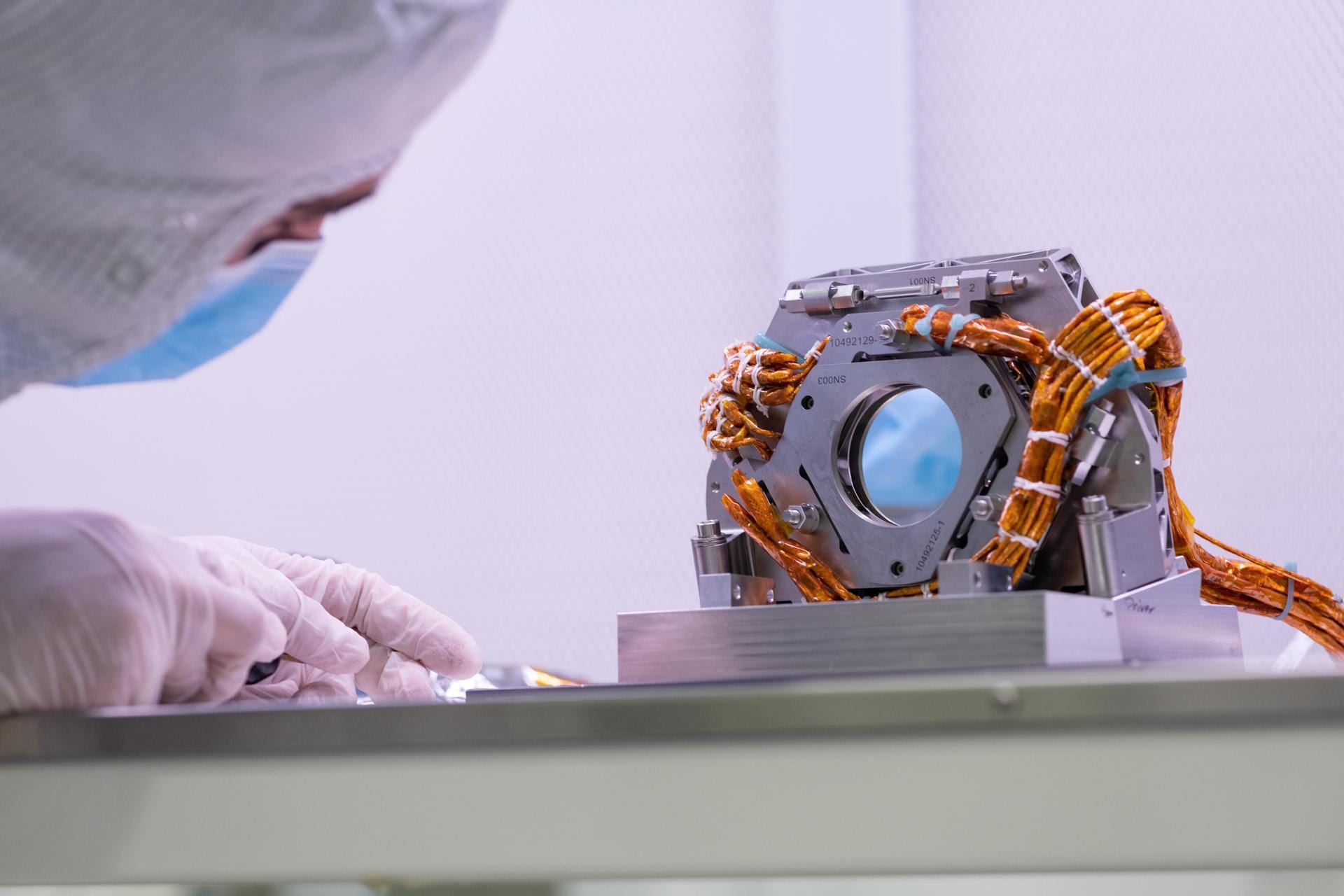 An engineer at NASA’s Jet Propulsion Laboratory with the fast steering mirror, a component of the Coronagraph Instrument that corrects for slight wobbling of the observatory.